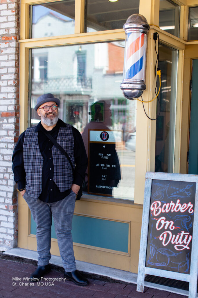 man in front of a barber shop
