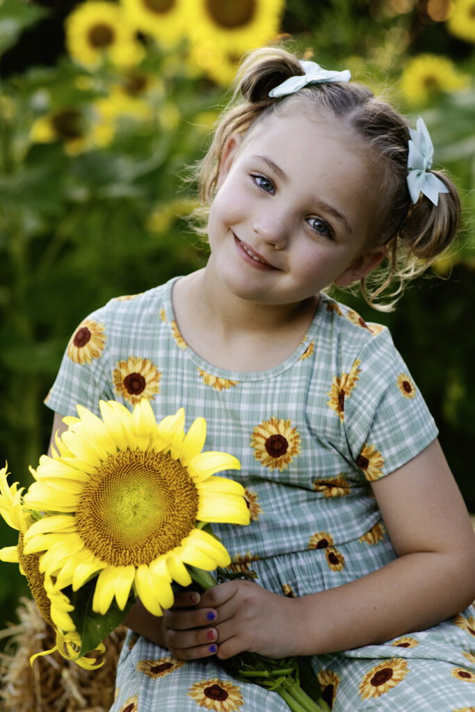 child in sunflowers