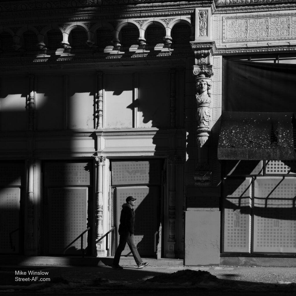 Man walking through shadows